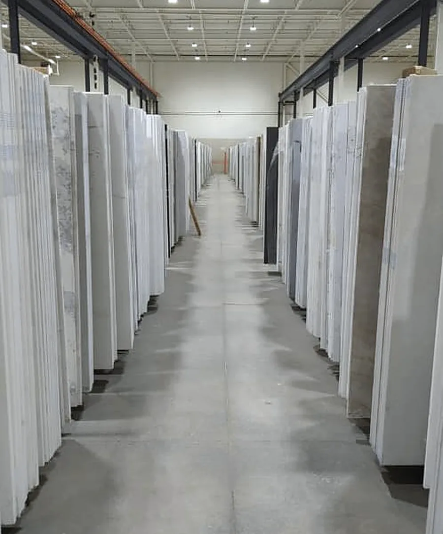 A long aisle of quartz slabs on racks